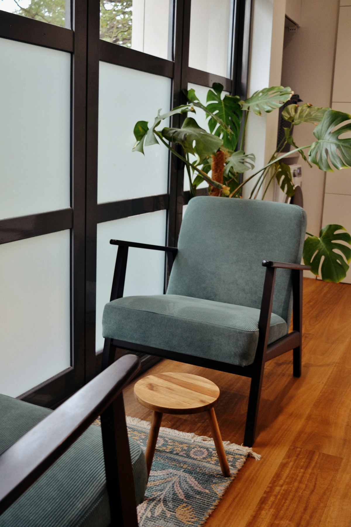 A calm counseling room with a chair by a window